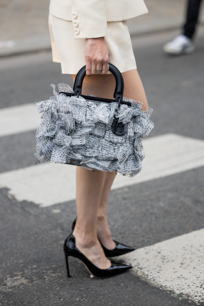 PARIS, FRANCE - JANUARY 23: Kozue Akimoto wears beige blazer, shorts, bag, heels outside Dior during Paris Fashion Week - Haute Couture Spring Summer  : Day One on January 23, 2023 in Paris, France. (Photo by Christian Vierig/Getty Images)